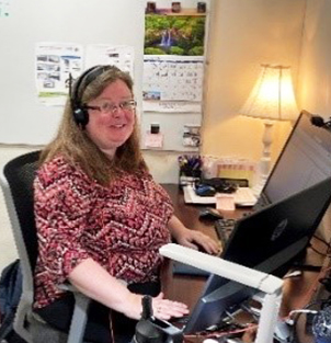 Audrey smiling for the camera from her office
