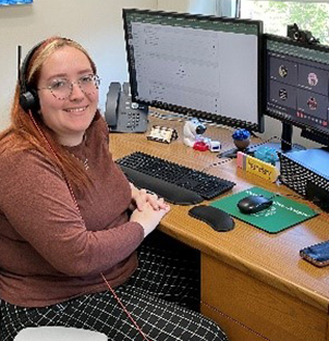 Brooke smiling from her desk