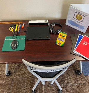 Student desk with a laptop and other school supplies