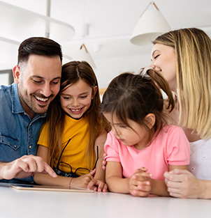 Parents helping two children