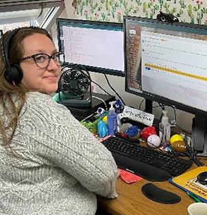 Kendra taking a picture from her desk